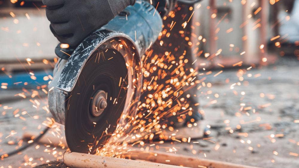 Angle grinder in use with sparks flying off the cutting blade