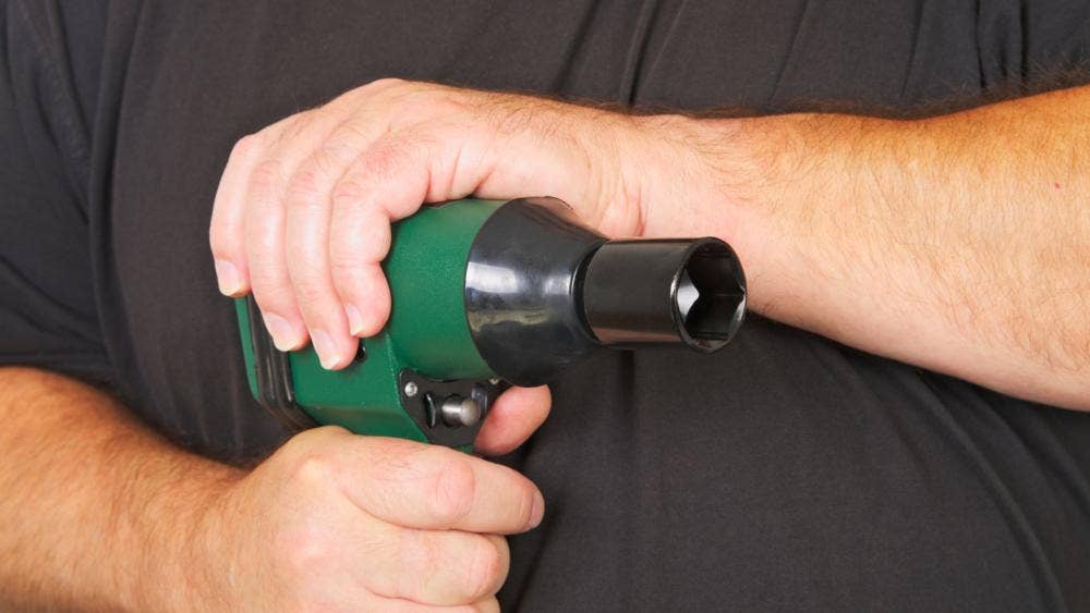 man holding an impact wrench