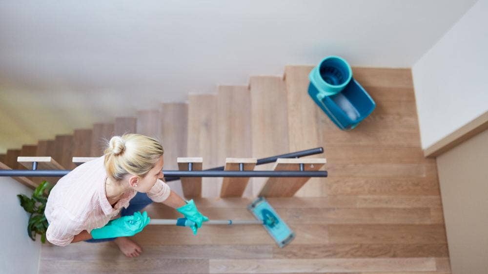 A woman cleaning a staircase