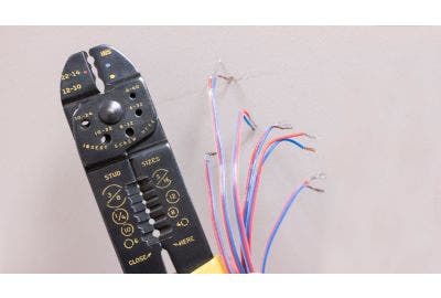 Wire strippers next to stripped wire