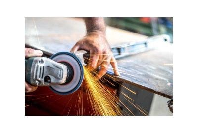 Angle grinder with sparks coming off the disc