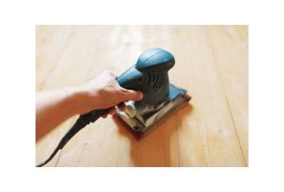 Electric sander sanding floor